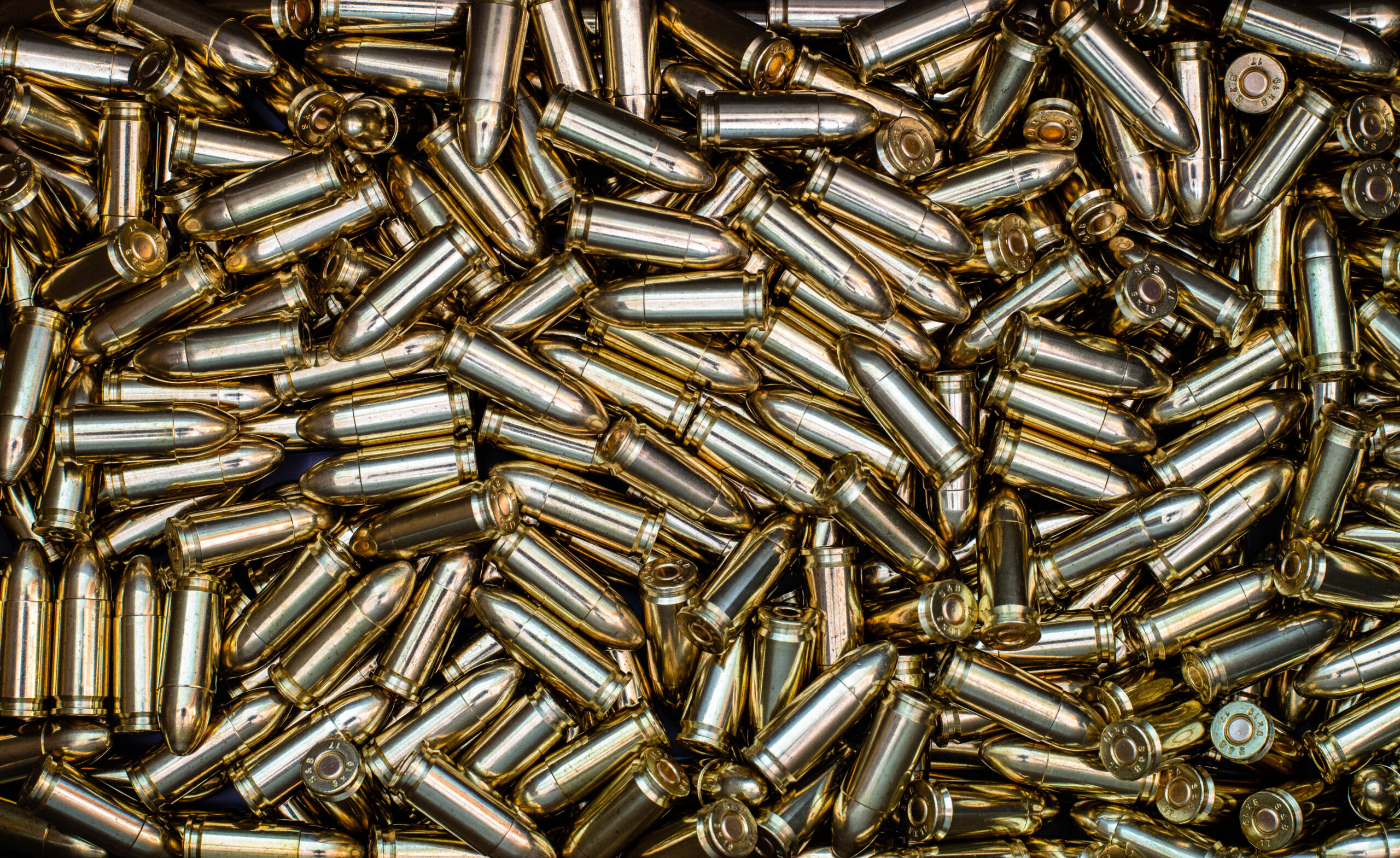 Rows of ammunition cartridges arranged on a range bench